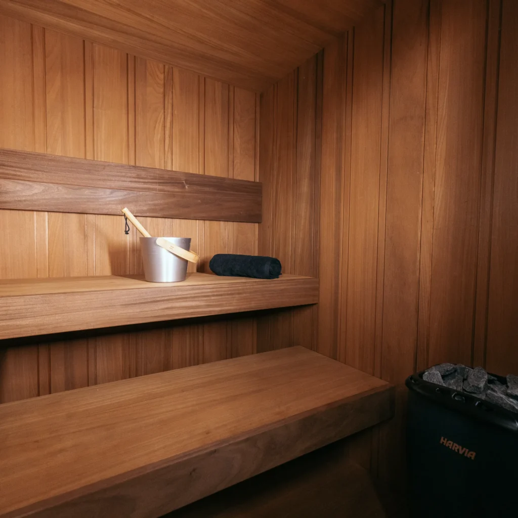 Thermo Abachi interior option with bench, bucket and heater in the OneEighty Large Outdoor sauna