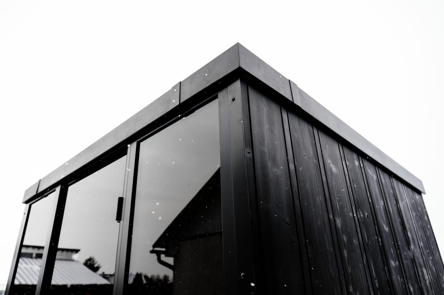 Architectural black cross-laminated timber OneEighty sauna exterior