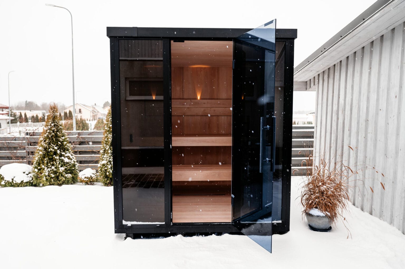 OneEighty modular cross-laminated timber sauna with the door open to a warm timber interior