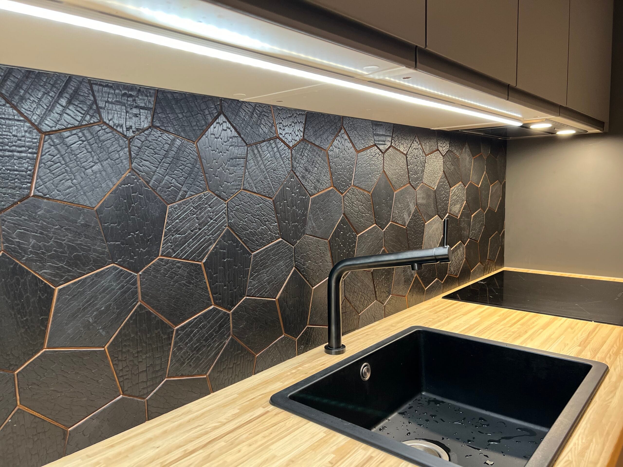 EmotionWood Hexagon wood panels behind a warm modern kitchen