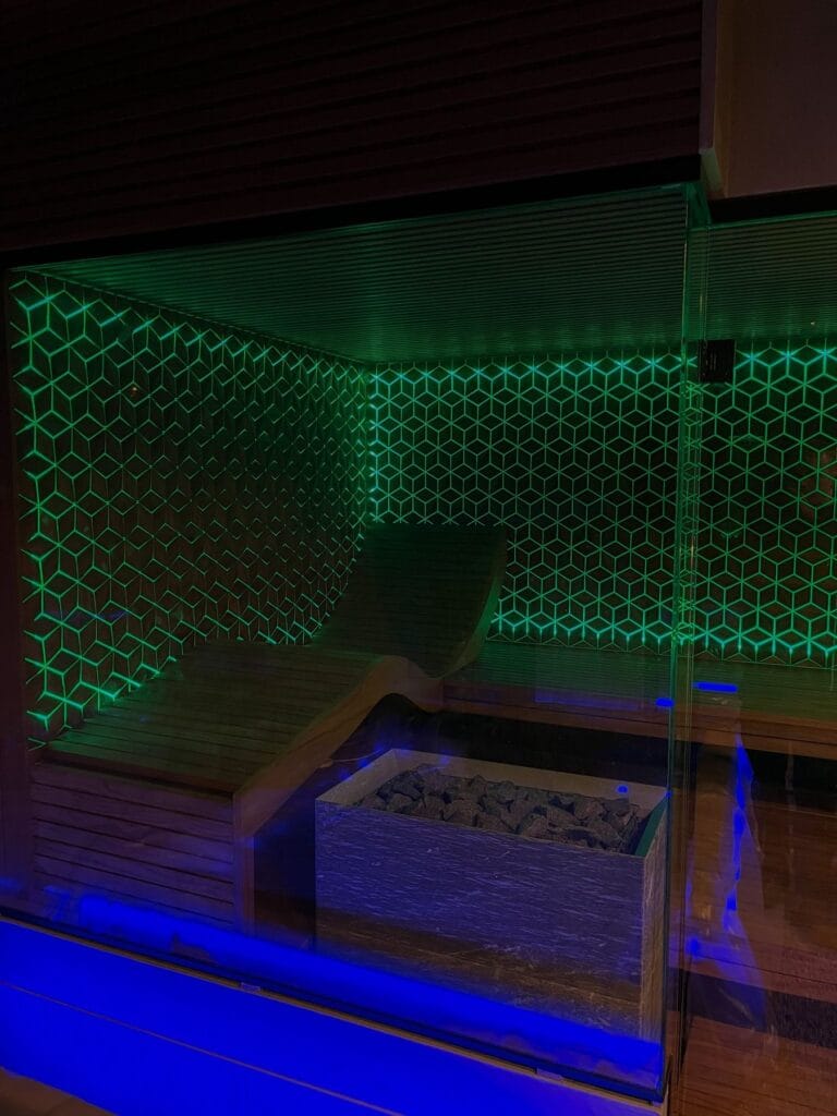 Quartz cube wood panel sauna with green LED backlight