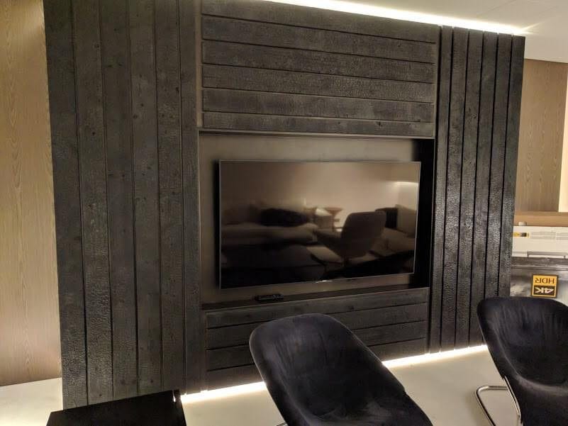 Interior media wall lined with charred yakisugi timber boards